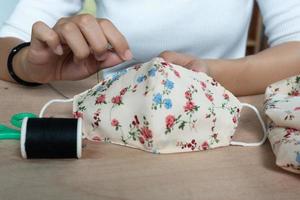 Making DIY masks at home sewing fabric mask handmade cotton protective equipment. photo