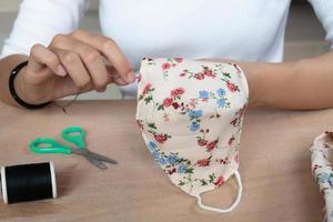 Making DIY masks at home sewing fabric mask handmade cotton protective equipment. photo