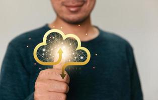 Businessman holding a cloud data icon with light. Computing data on network. Insurance Business computer security concept. photo