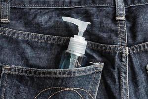 Anti-coronavirus spray. A man Carry it in the pant pocket photo
