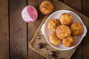 Fruit muffins with nutmeg and allspice on a wooden background photo