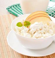 Cottage cheese with apples and sour cream for breakfast close up photo