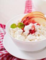 Cottage cheese with apples and sour cream for breakfast close up photo