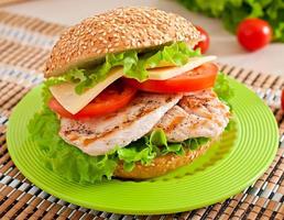 Chicken sandwich with salad and tomato photo