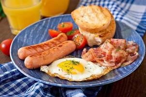 English breakfast - toast, egg, bacon and vegetables in a rustic style on wooden background photo