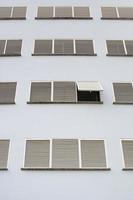 Building with only one open window shutter photo