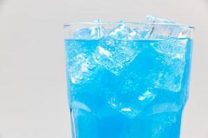 Blue Hawaii sparkling water with ice cubes close-up. photo