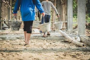 The concept of child labor, Poor children are forced to work in construction, Violence children and trafficking concept,  Rights Day,  World Day Against Child Labour concept photo