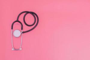 stethoscope on pink background and copy space photo