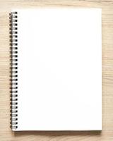 Blank spiral bound notepad mockup template with Kraft Paper cover, isolated on wood background. photo