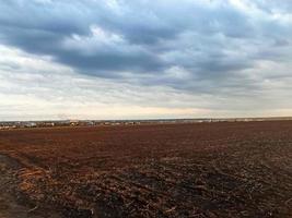 Sunset over a plowed field. Summer evening photo