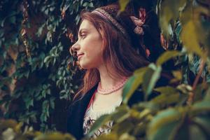 Portrait of brunette woman dressed in historical Baroque clothes with old fashion hairstyle, outdoors. photo