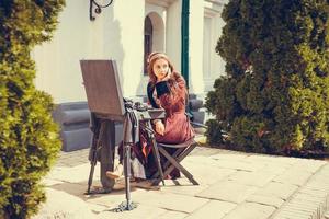 Portrait of brunette woman dressed in historical Baroque clothes with old fashion hairstyle, outdoors. photo