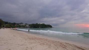 10.12.2021 People walk, swim and watch the sunset, at Kata Beach, Phuket. video