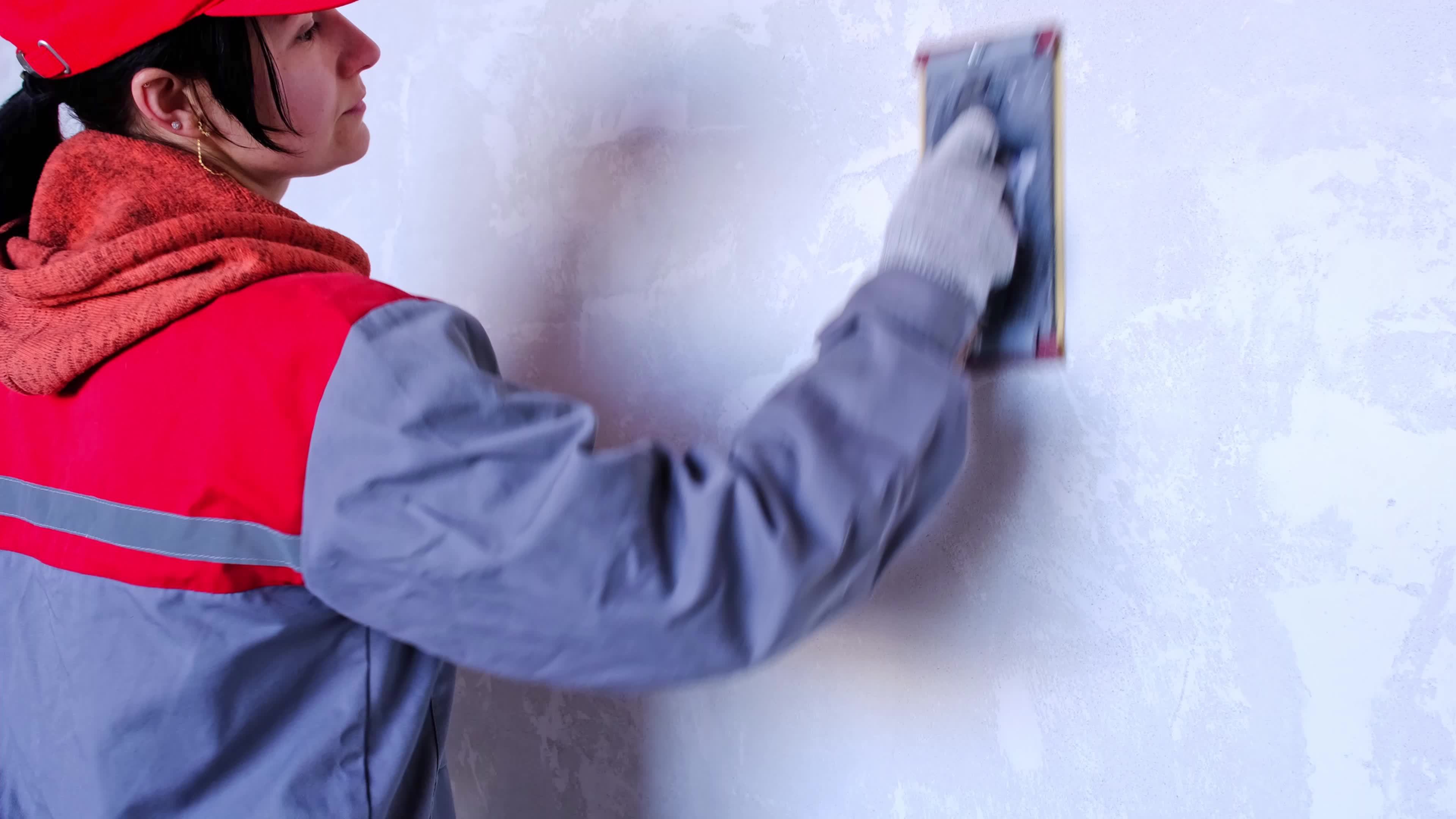 Sanding of walls with sandpaper after treatment with dry building mixes