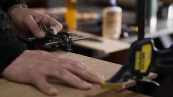 carpenter in the workshop makes furniture with a hand tool video