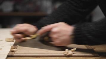 a carpenter using a hand planer levels the surface of a walnut wood blank video