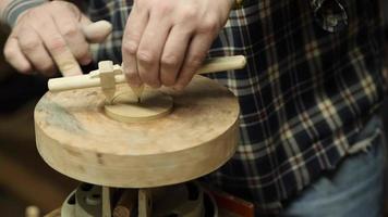 a potter cuts a circle of clay with a compass video