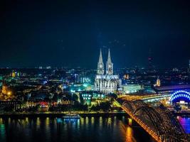 HDR Aerial night view of St Peter Cathedral and Hohenzollern Bri photo