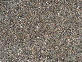 grey pebbles set into concrete texture background photo