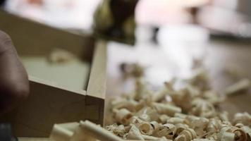 a carpenter using a hand planer levels the surface of a walnut wood blank video