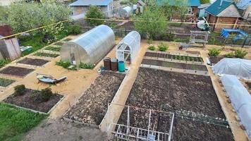 Top view of the vegetable garden. A snapshot of beds of mixed vegetables growing on tiled beds.