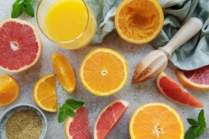 Glass of juice and citrus fruits photo