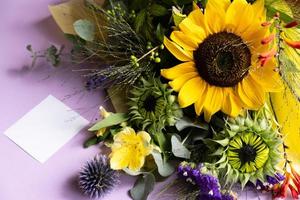 Fresh cut sunflowers in bouquet and card with envelope with copy space. photo