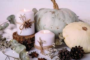 Autumn composition with pumpkin and candles. Beautiful autumn decor photo