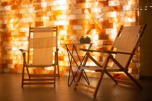 Salt room interior with armchairs and salt block wall in spa photo
