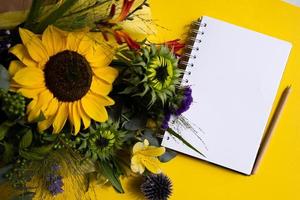 Fresh cut sunflowers in bouquet and card with envelope with copy space. photo