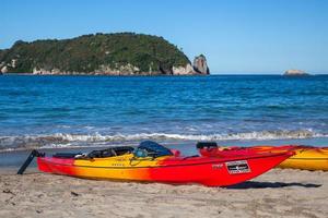 Evening sunshine on kayaks at Hahei beach in New Zealand on February 8, 2012 photo