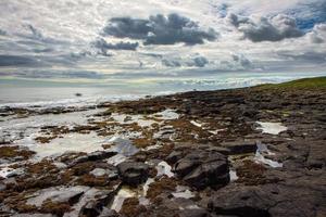 View of the Rocky Shoreline near Dunstanburgh Castle photo