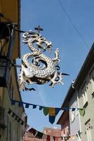 Dragon sign above a restaurant in Sighisoara Transylvania Romania on September 17, 2018 photo