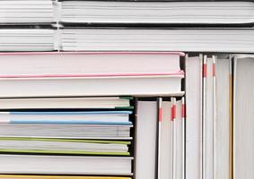 books stacked in a pattern. background for back to school concept. pile of hardcovered books photo