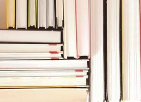 collection of hardcovered books stacked in a pile. pattern made of books. learning and study, literacy and education concept. photo