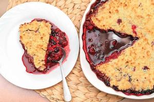 piece of cobbler pie with blackberry and raspberry, home baked crumble pie. tasty summer dessert. gluten free sweet treat. photo