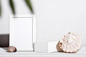 summer holiday mockup, tropical vacation and sea travel. white frame and seashells next to white podium or pedestal for product placement. display showcase mockup. photo