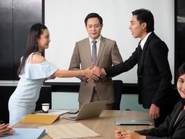 Businesswoman shake hand businessman manager office company group promise agreement contract teamwork job career investment customer partnership project.Female and male very happy smile successful photo