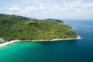 High angle view Tropical sea with wave crashing on seashore and high mountain located in Phuket Thailand aerial view drone top down Amazing nature view landscape Beautiful sea surface. photo