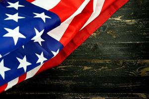 American flags on black wood background,image for 4th of july independence day Flag of USA on dark wooden wall texture background. photo