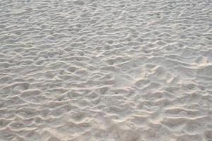 Detail of texture sand in tropical island Summer background and travel design. photo