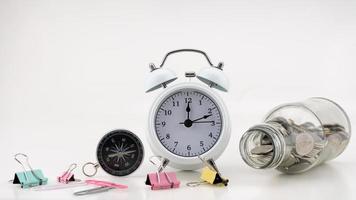 Concept Business finance and Shopping sale Coins in jar with White alarm clock Business objects isolated on white background photo