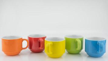 Colorful coffee cup on colorful paper background A lot of cups for coffee and tea in coffee shop Food and drink background concept photo