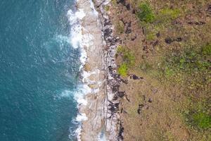 Aerial view Top down seashore wave crashing on seashore Beautiful turquoise sea surface in sunny day Good weather day summer background Amazing seascape top view photo