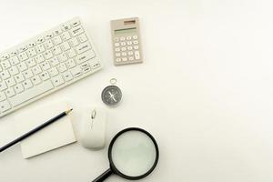 Business objects of Pc,keyboard,mouse,pencil,compass and calculator,Magnifying glass on White table background. photo