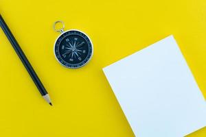 Top view business objects of white paper,pencil,and compass on paper work yellow background Flat lay composition. photo