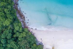 Aerial view Top down seashore wave crashing on seashore Beautiful turquoise sea surface in sunny day Good weather day summer background Amazing beach top view photo