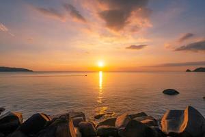 Landscape Long exposure of majestic clouds in the sky sunset or sunrise over sea with reflection in the tropical sea Beautiful seascape scenery Amazing light of nature sunset photo