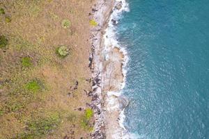Aerial view Top down seashore wave crashing on seashore Beautiful turquoise sea surface in sunny day Good weather day summer background Amazing seascape top view photo
